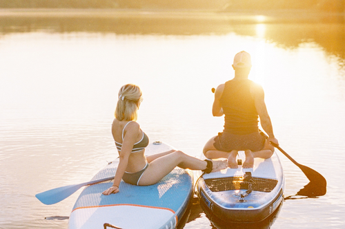paddle_boarding_while_on_a_campsite_holiday_for_couples